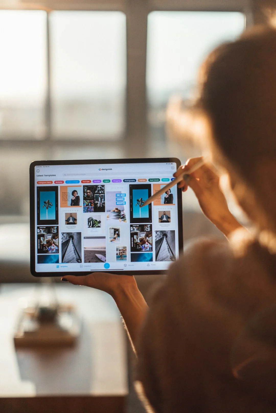Close-up of hands interacting with a shopping website on a laptop screen indoors.
